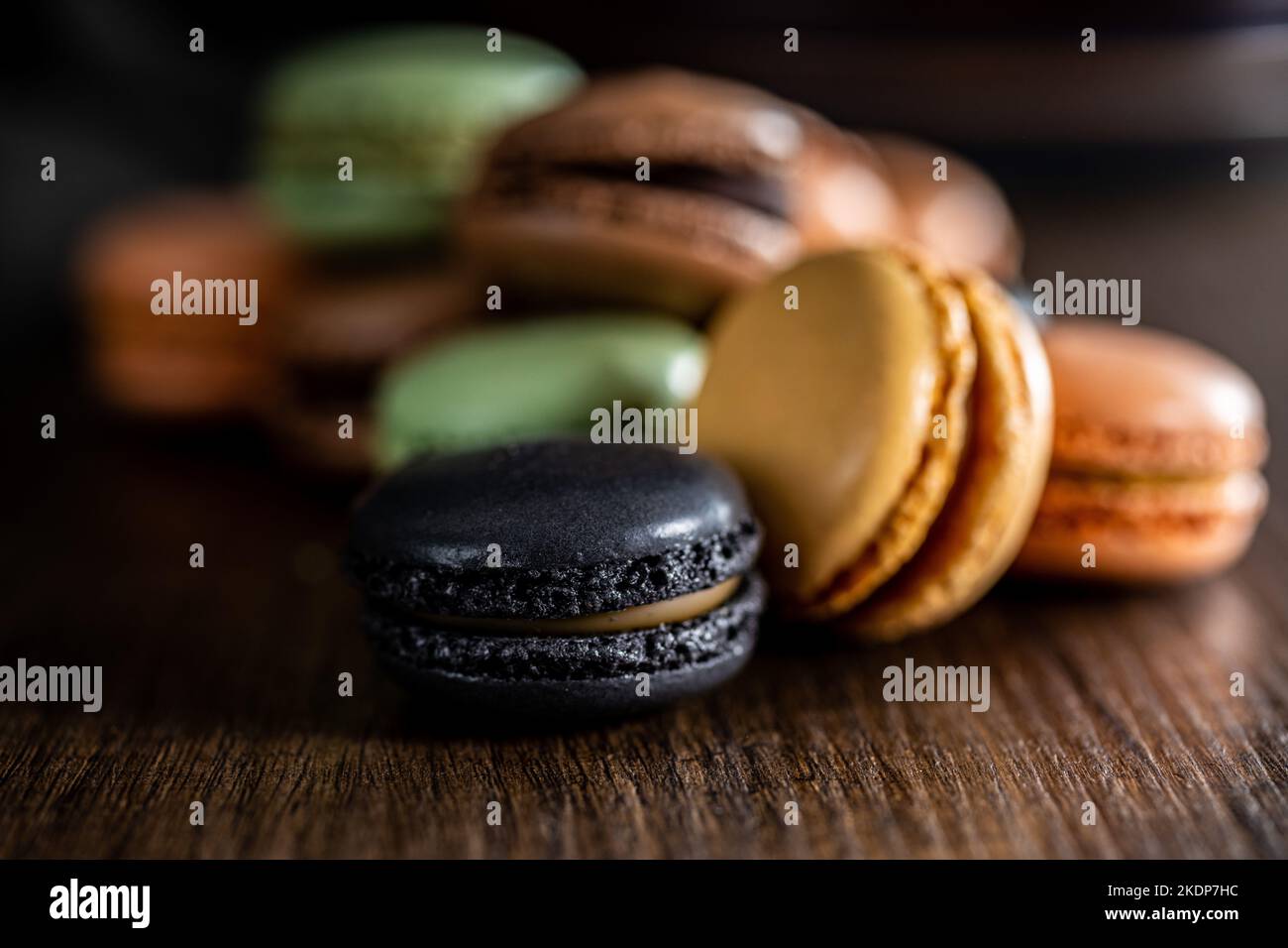 Sweet macaron dessert. Colorful macarons on the wooden table. Stock Photo
