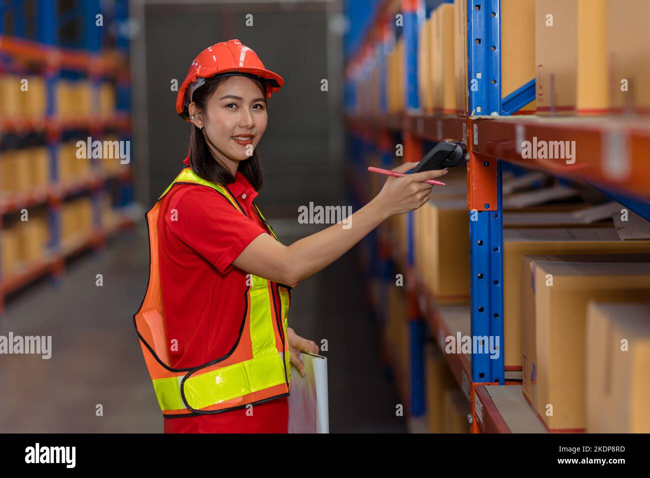 Portrait Asian worker warehouse stock control staff work checking inventory amount using bar code scanner Stock Photo