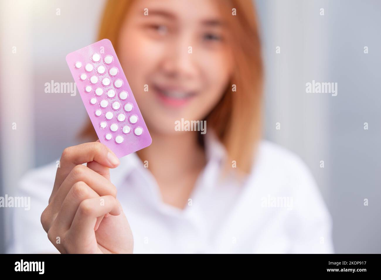 teen girl with birth control pills Combined Oral Contraceptive Pill, COCP show up happy smile Stock Photo