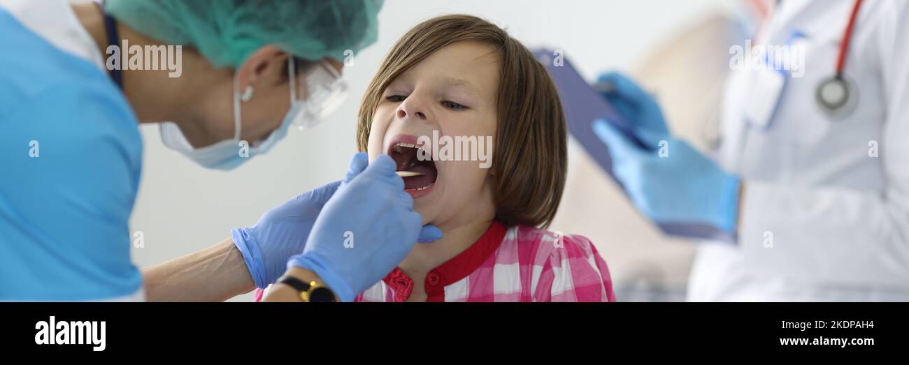 Female nurse takes cotton bud to analyze saliva, nasal swab, mucous membrane for DNA tests Stock