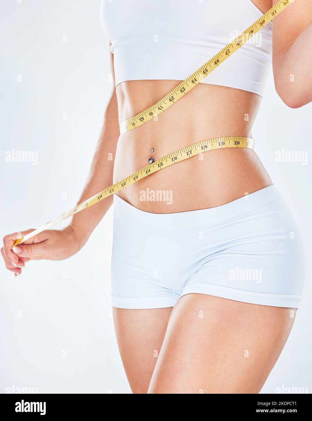 Woman Measuring Waist Using Tape Measure Mid Section High-Res Stock Photo -  Getty Images