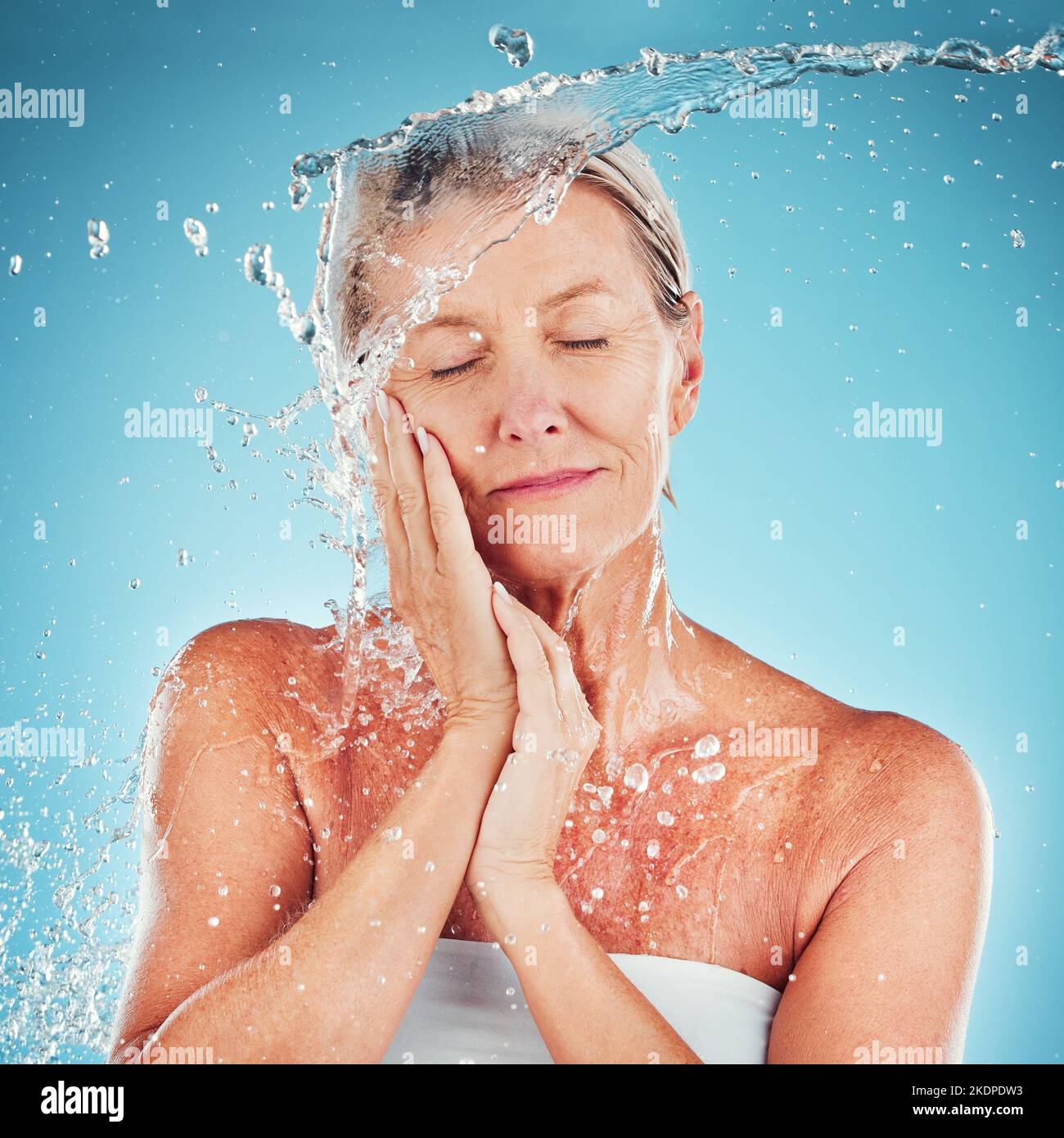 Senior woman, water and skincare for hydrate, hygiene and fresh clean treatment against a blue