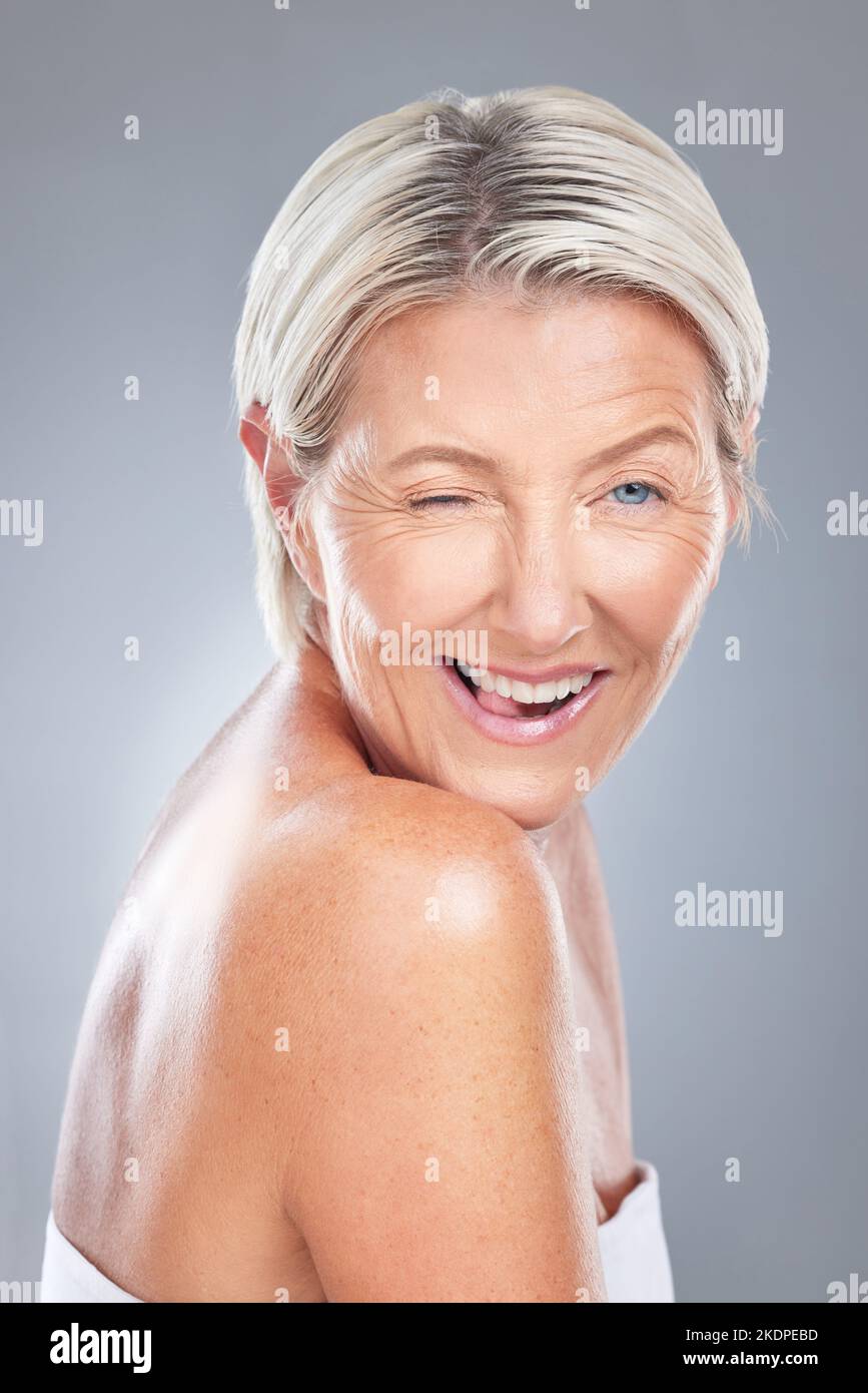 Wink, funny and senior beauty woman face happy about skincare and wellness. Portrait of an elderly model from Scandinavia with happiness of Stock Photo