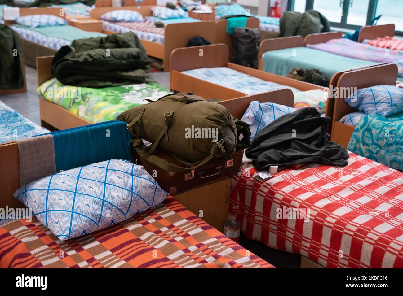 The belongings of mobilized Russian soldiers in the training center. A duffel bag lies on the bed. Mobilization in Russia.  Stock Photo