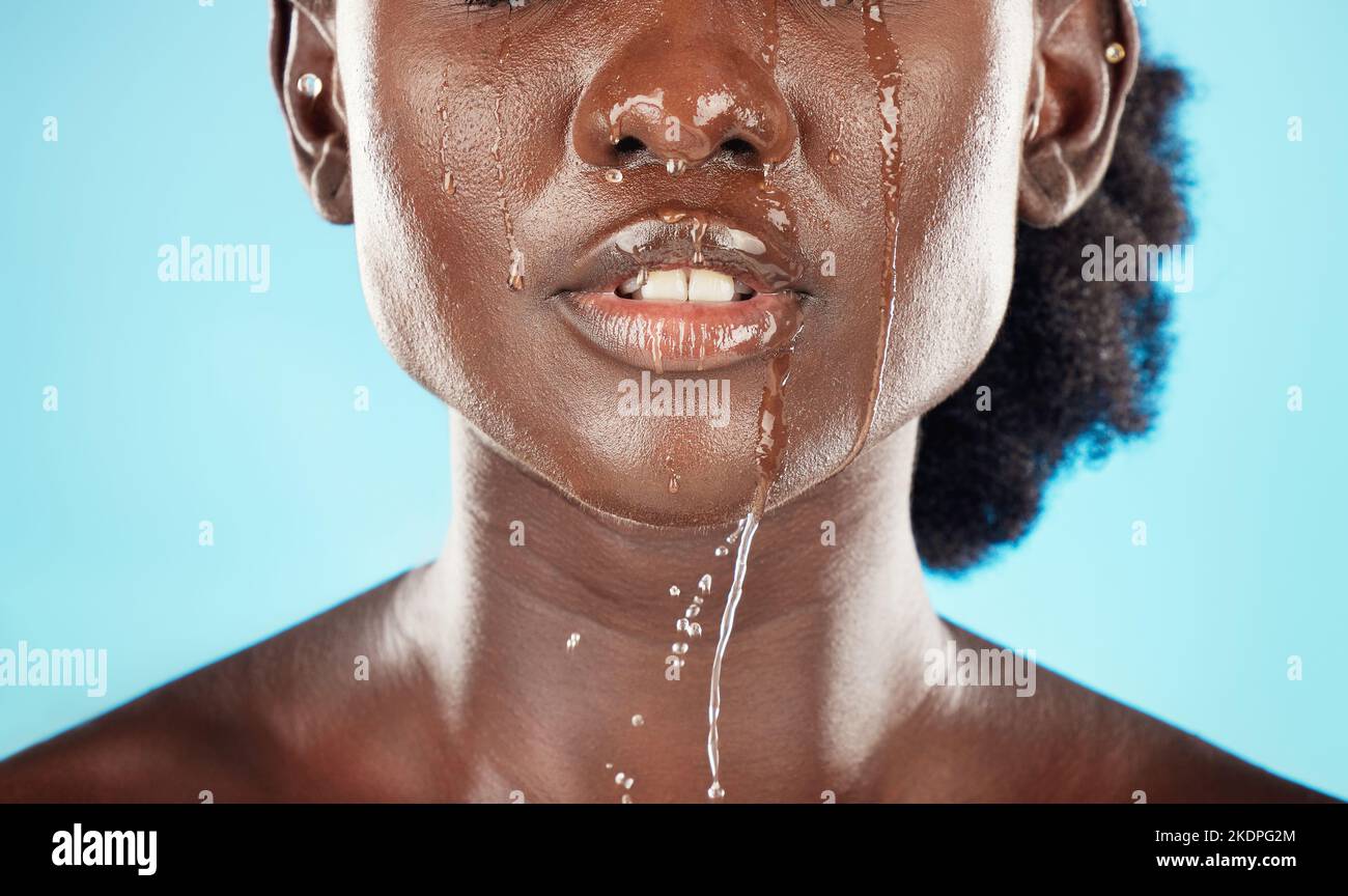 Water, mouth and face of a black woman with drops on her lips for hygiene, grooming and cleansing. Beauty, skincare and hydrating facial for an Stock Photo