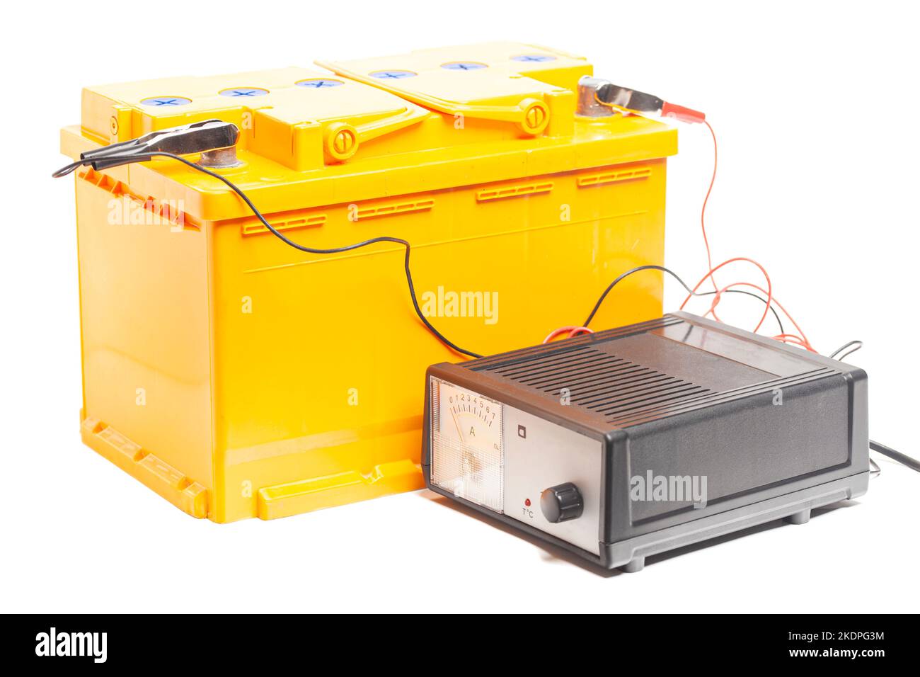 yellow car battery with car battery charger isolated on white