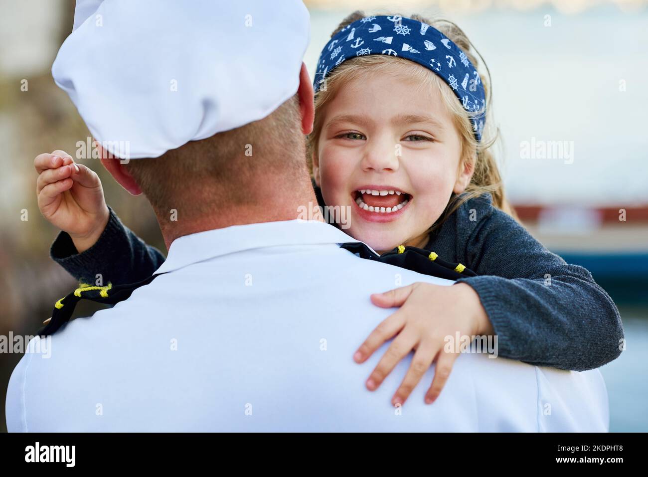 Made you look. Rearview shot of a father in a navy uniform hugging his happy little girl. Stock Photo