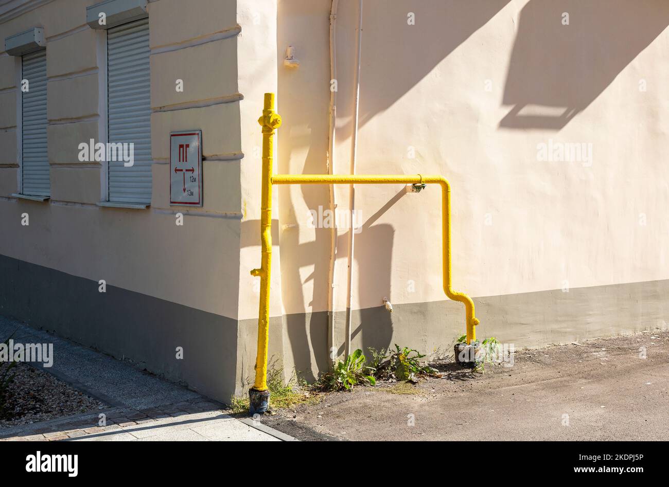 Gas entry point to a residential building. Gas pipes with valve on the building wall. Gas distribution point in an apartment house Stock Photo