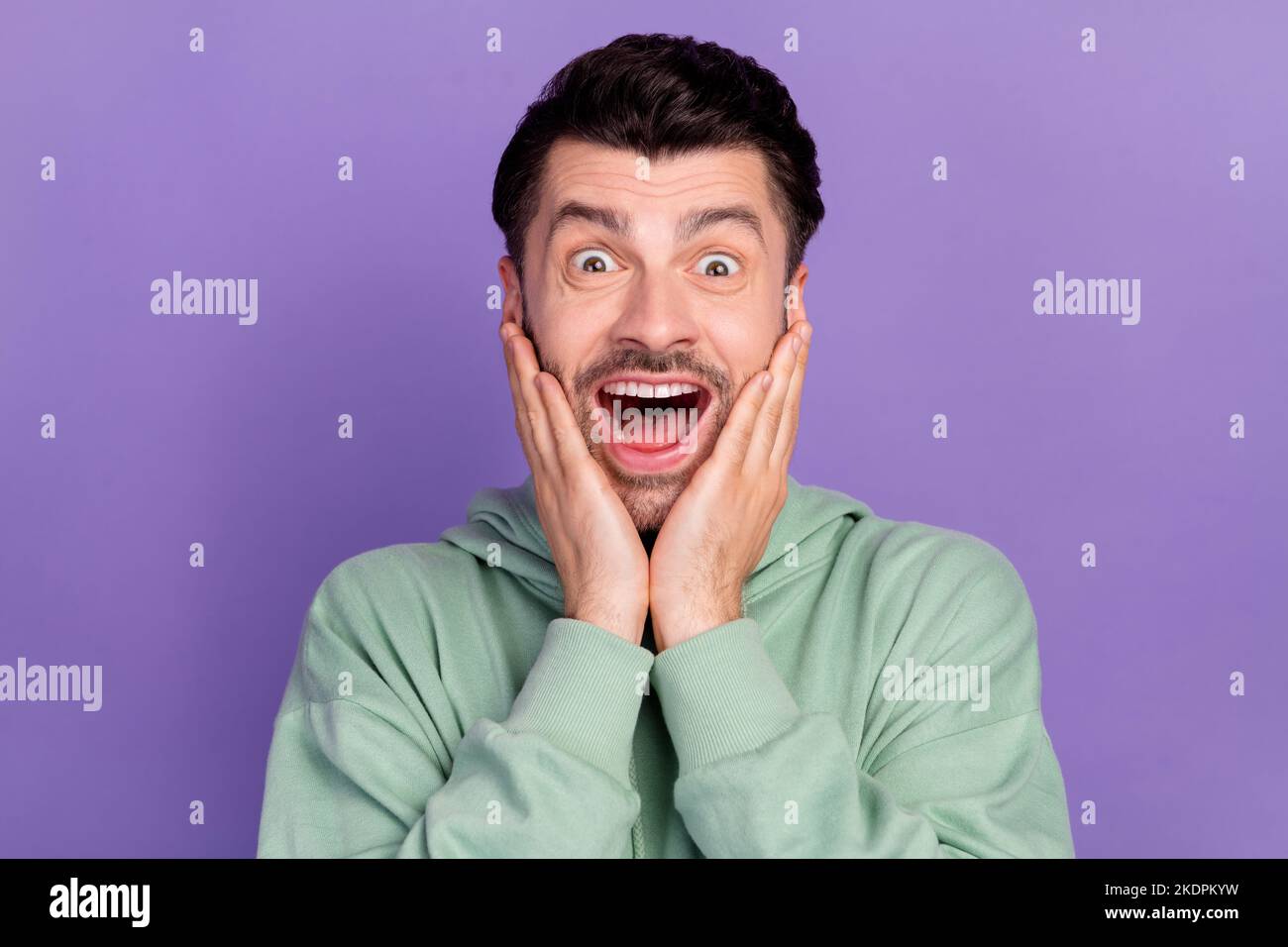 Closeup photo of funny astonished positive student guy touch cheeks ...