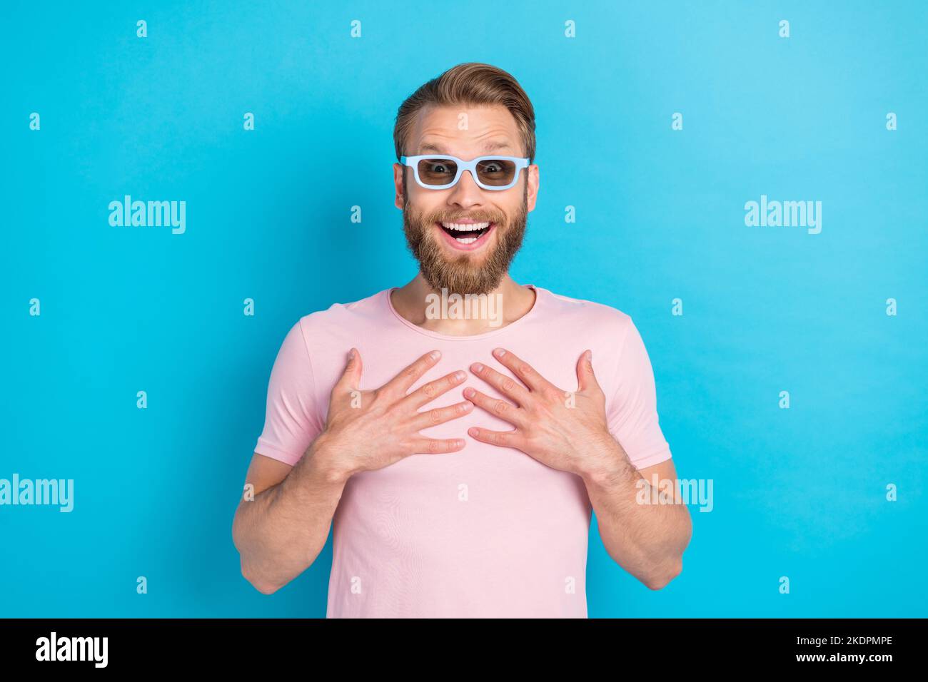 Photo of funky shocked man wear pink tshirt dark glasses arms chest