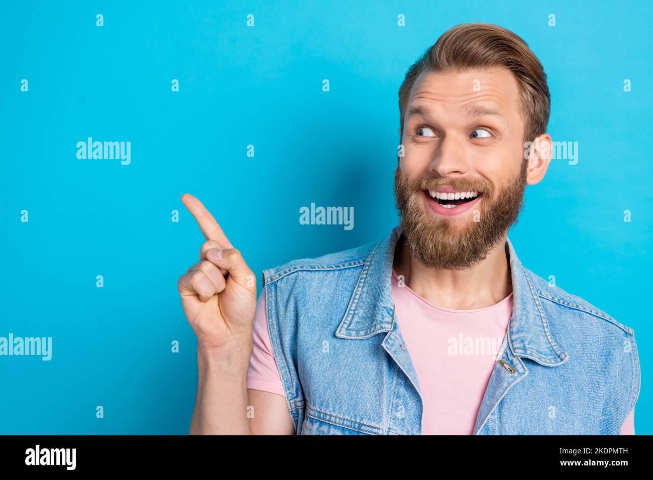 Photo Of Funky Excited Young Man Wear Jeans Waistcoat Pointing Finger Looking Empty Space 6631