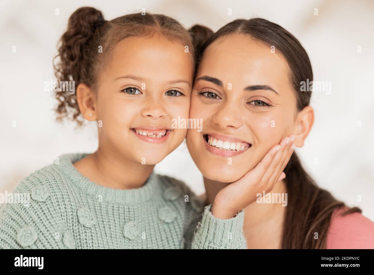 Mother, daughter and face portrait of love, care and bond together on a blur background. Woman, child and caring parent with her kid for bonding Stock Photo