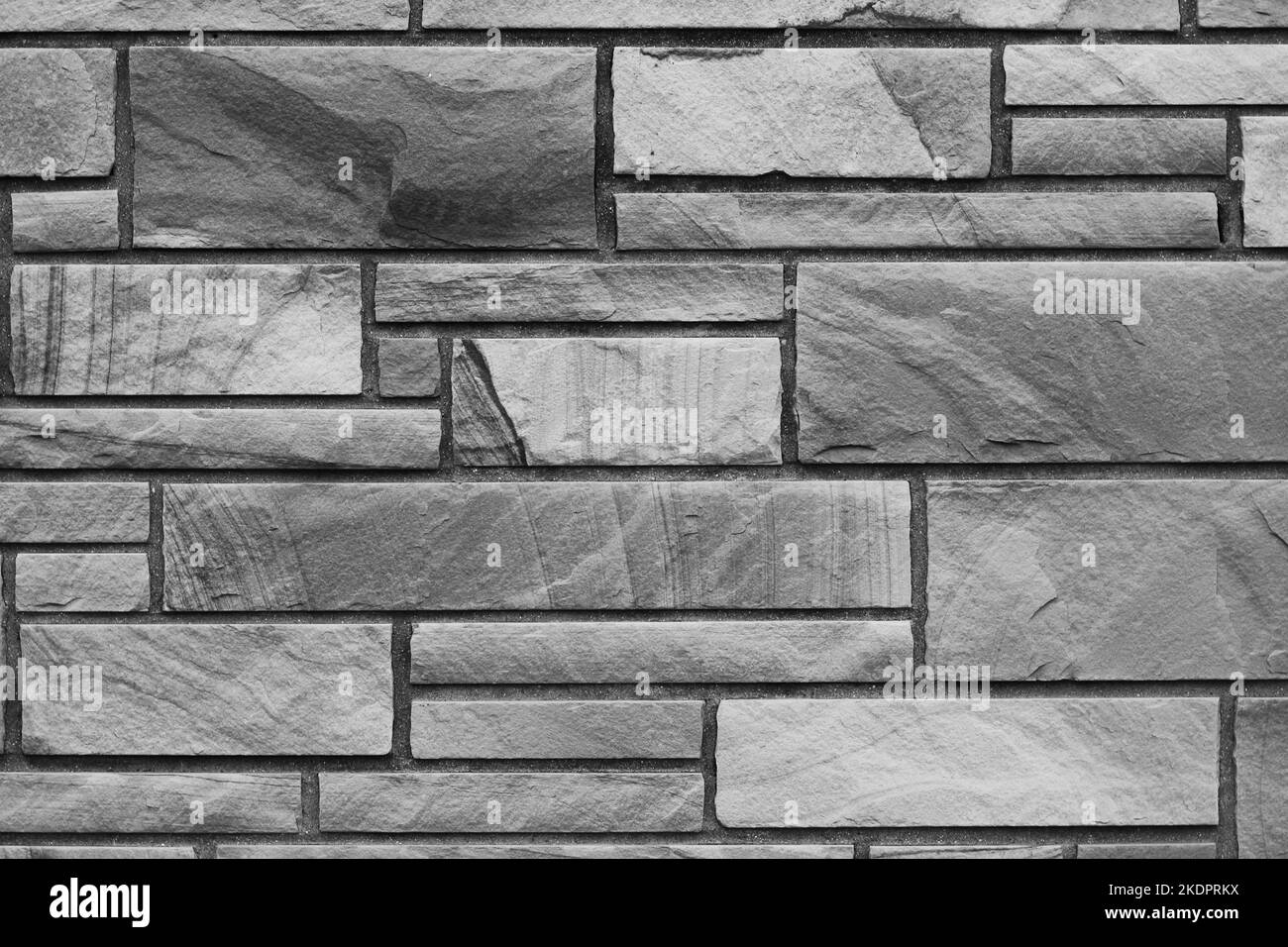 Solid brick wall created with natural stone bricks in a random pattern ...