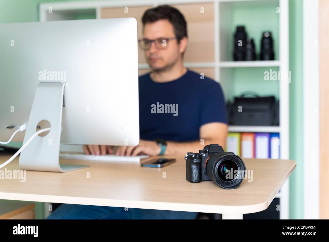 Photographer in his office working on the computer Stock Photo - Alamy