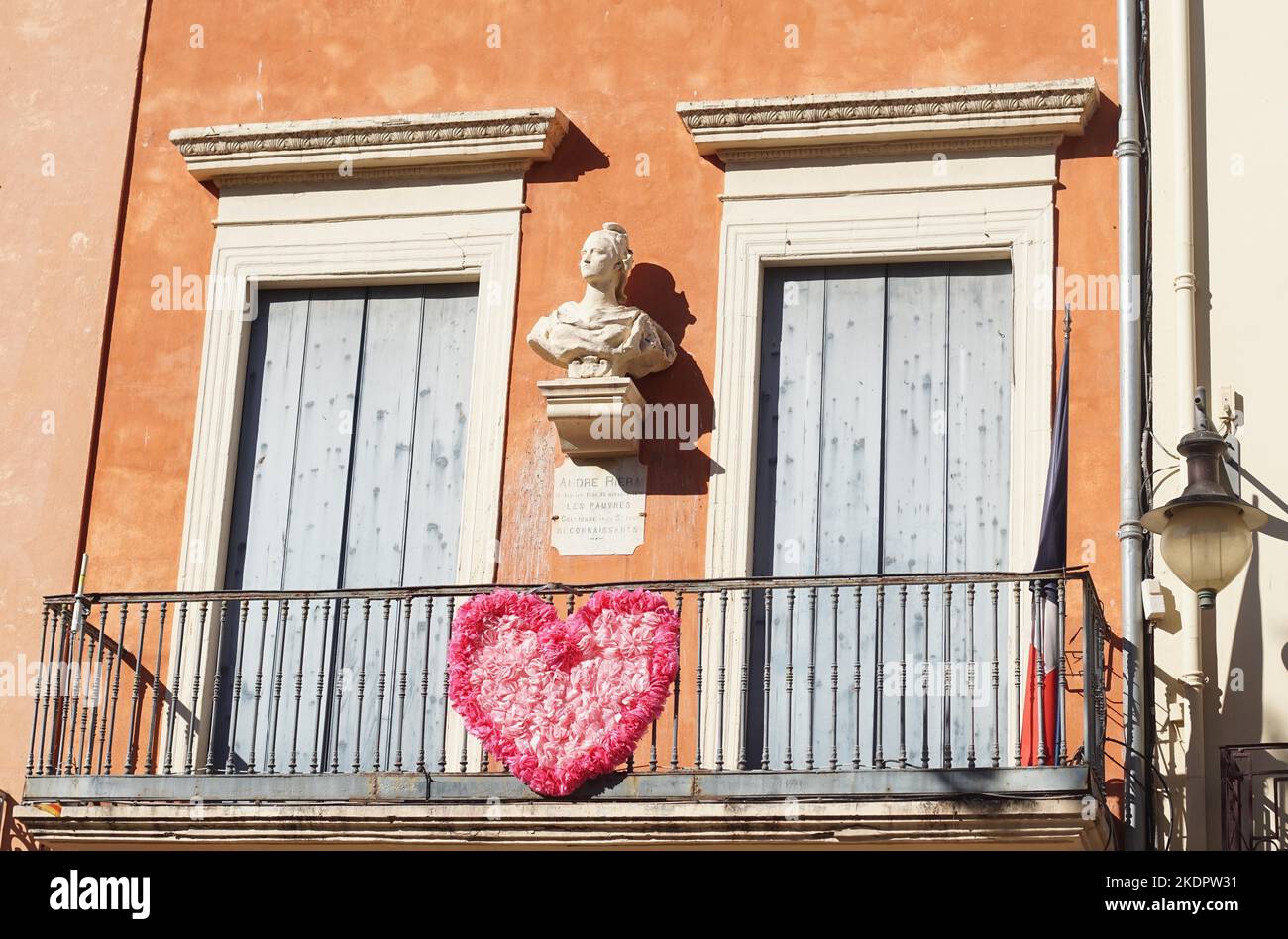 Collioure, France - October 2022: House front balcony featuring bust and plaque commemorating Andre Riera (1744-1836) Stock Photo