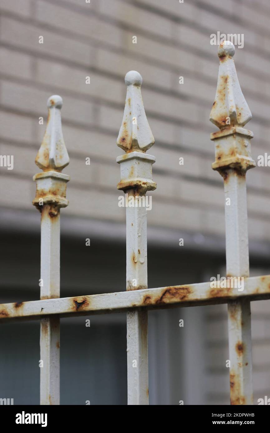 Vintage rusty metal fence with a row of decorative finials Stock Photo