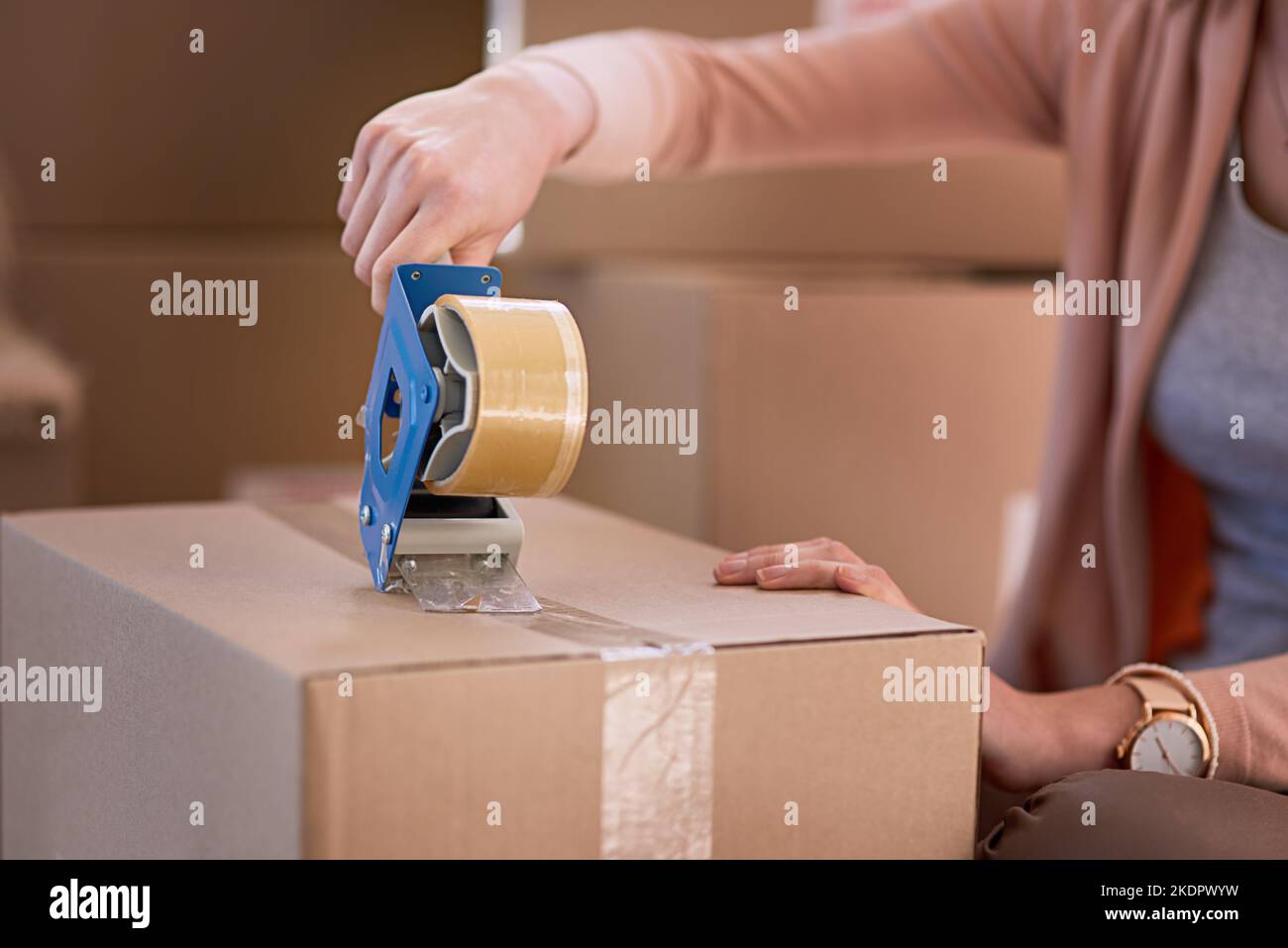 Sealed and ready to go. an unidentifiable woman packing boxes while moving house Stock Photo Alamy