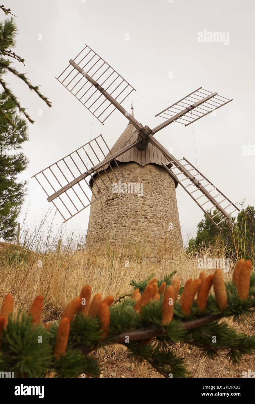 Moulin d'Omer, a restored, fully functional windmill sitting on hill top in village of Cucugnan, Aude Department, France Stock Photo