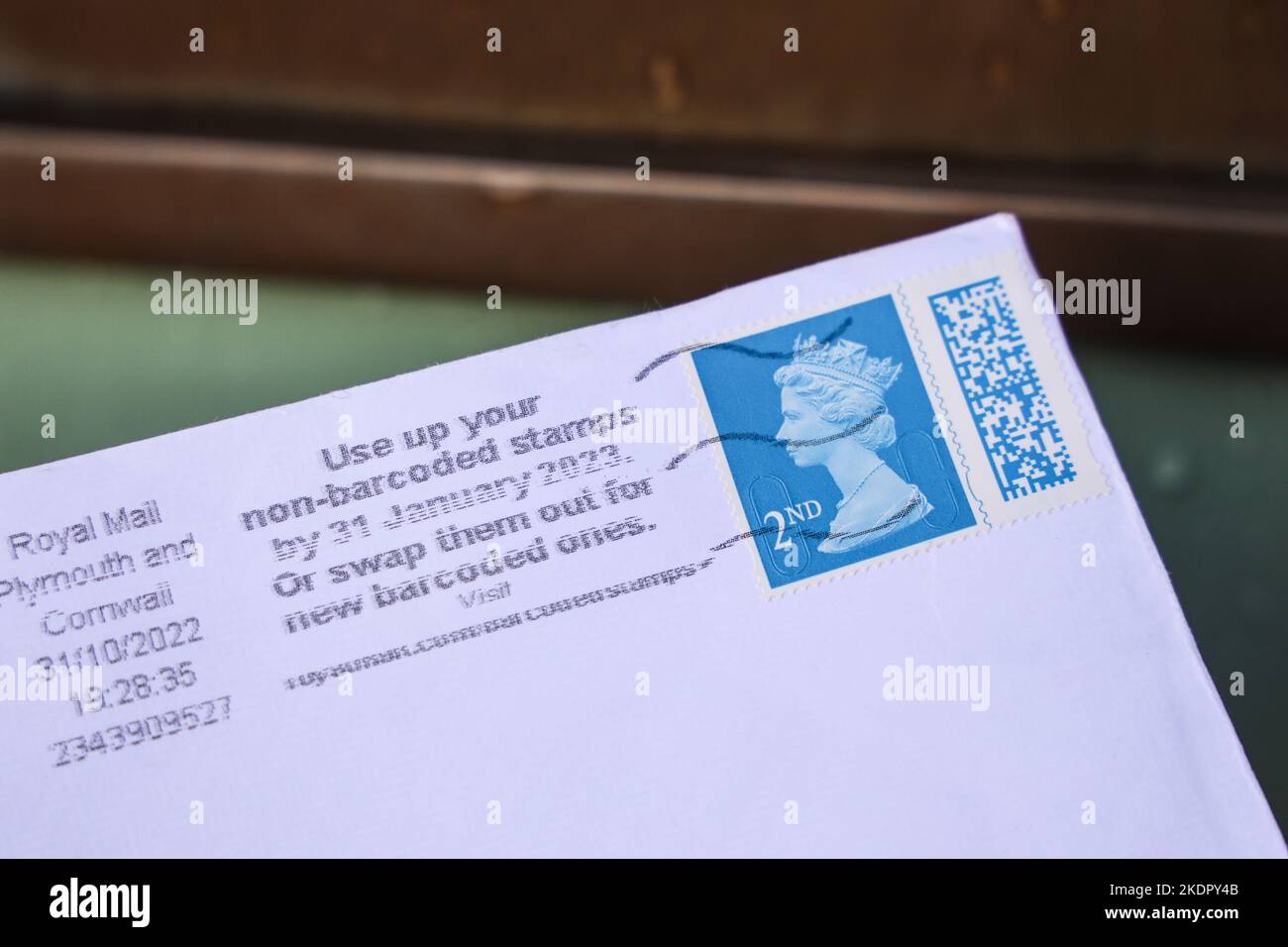 A warning to use up non barcoded posted stamps on the frank of a second class stamp. It still features Queen Elizabeth II Stock Photo