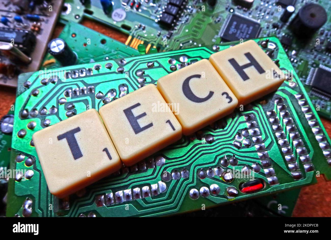 Tech - Scrabble letters / word on a green electronic PCB, circuit board Stock Photo