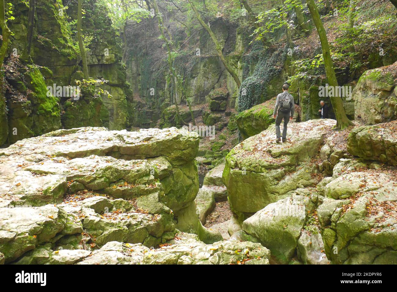 Hikers in the Gaja Gorge, Romai Furdo, the temporarily dried up Roman Baths waterfall,  Bakony Hills, Hungary Stock Photo