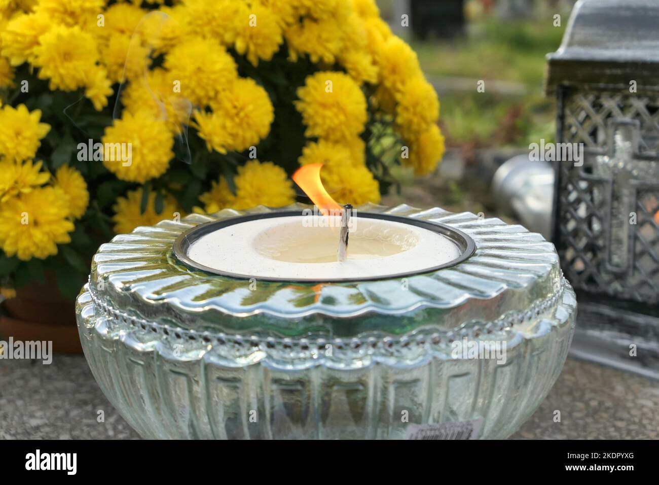 Burning candle on the grave. All the Saints Day holiday on 1 November