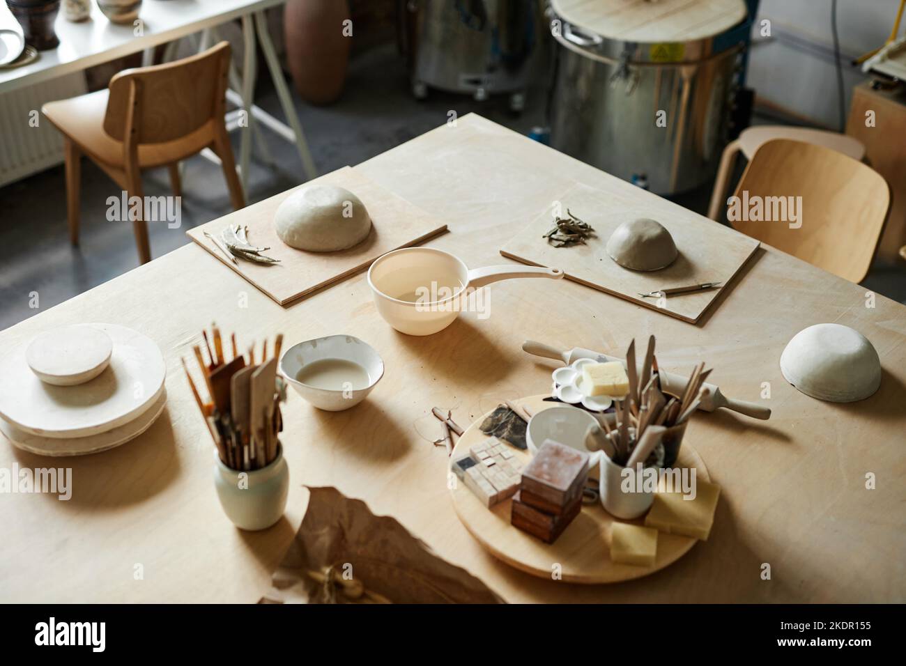 High angle background image of clay and art supplies on table in cozy pottery studio, copy space Stock Photo