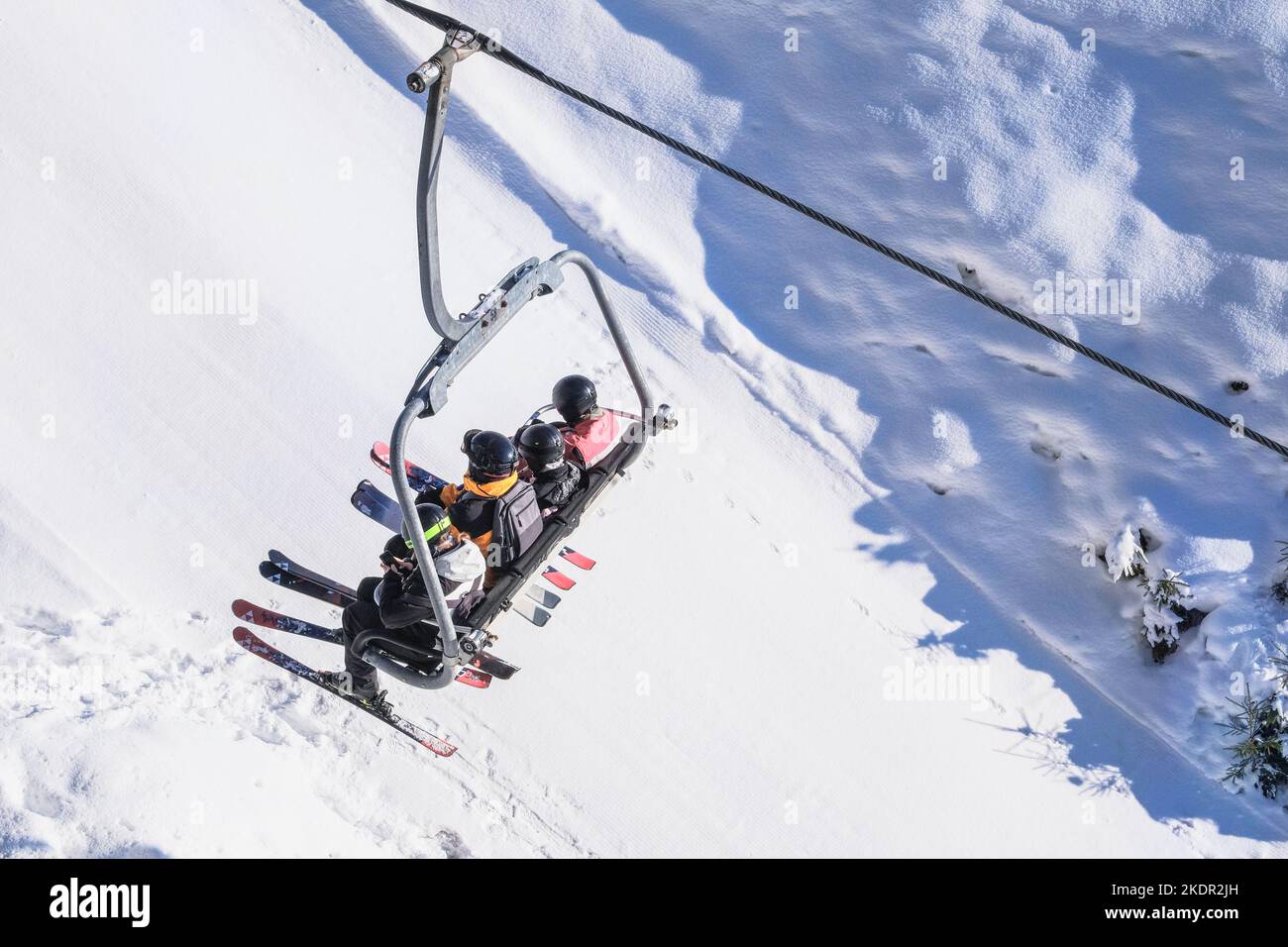 Skiers go up the mountain on the lift. Skiing in winter. Stock Photo