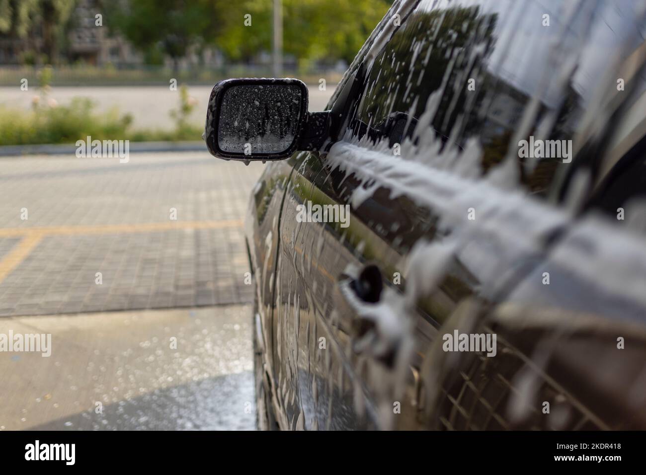 Washing mirrors in a car with active foam. Car wash Stock Photo Alamy