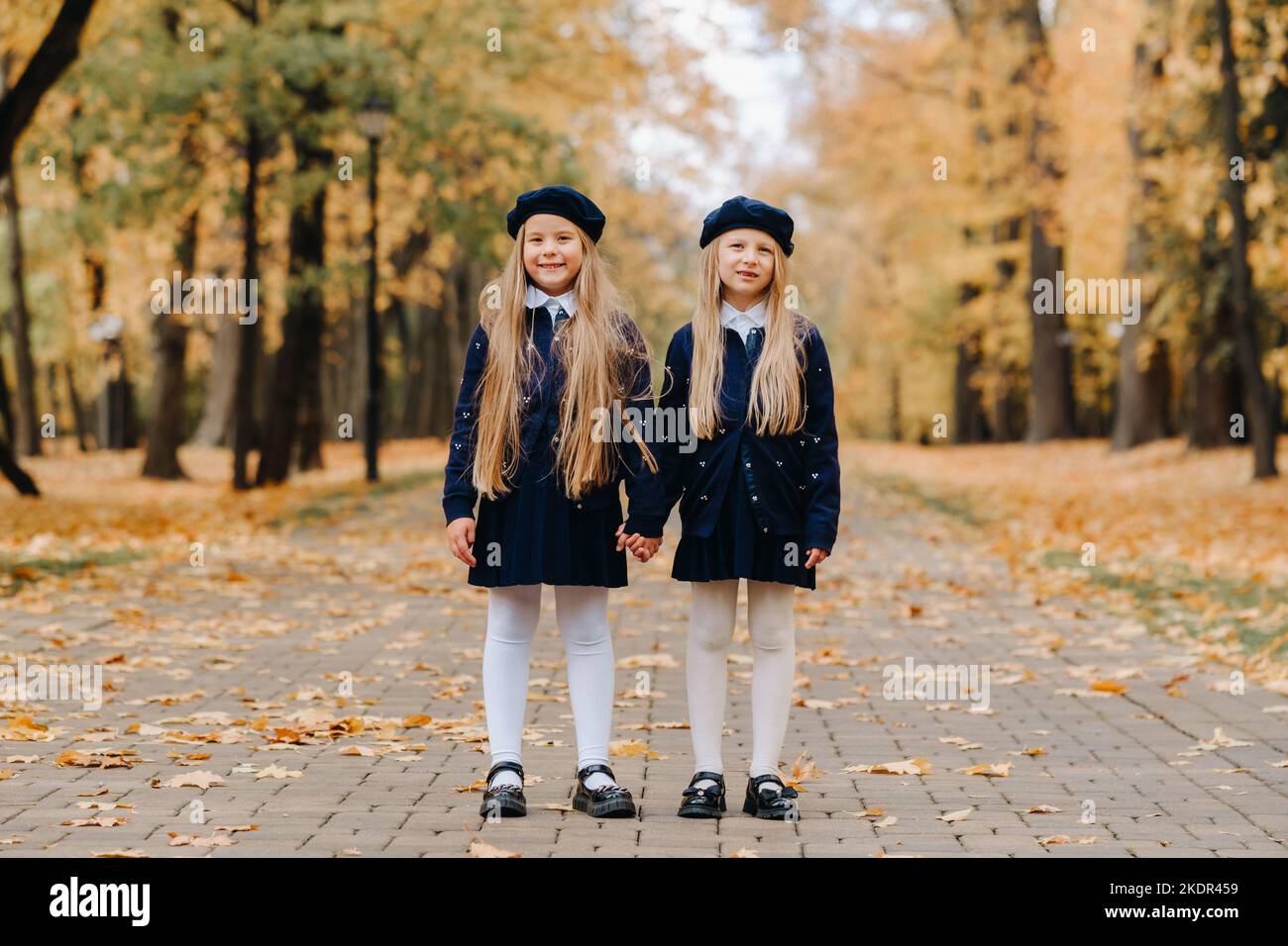 Happy children holding hands in a beautiful autumn park Stock Photo - Alamy