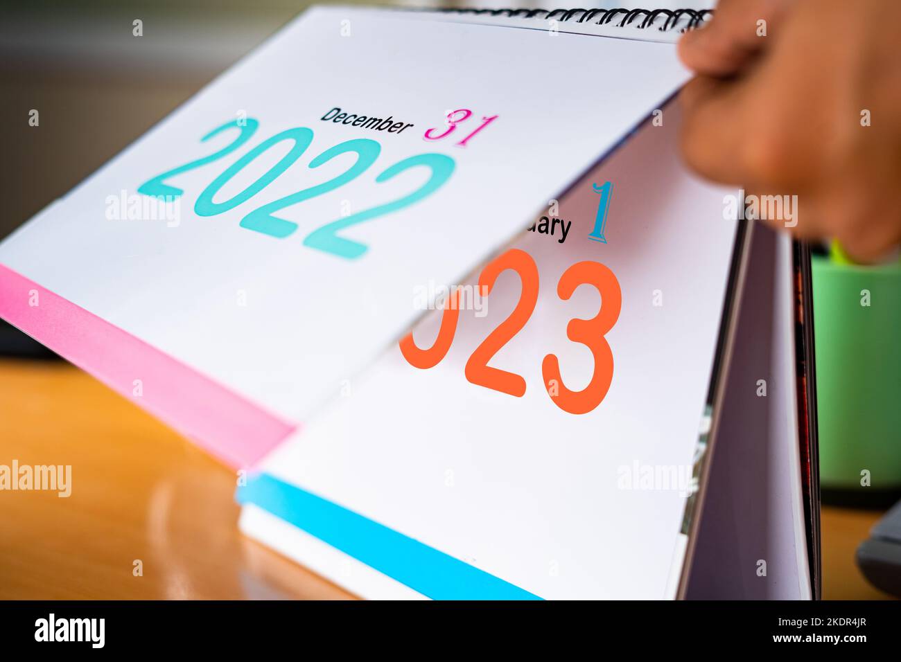 close up handheld shot of change calendar from 2022 to New year January 2023 - concept of fresh or new start Stock Photo