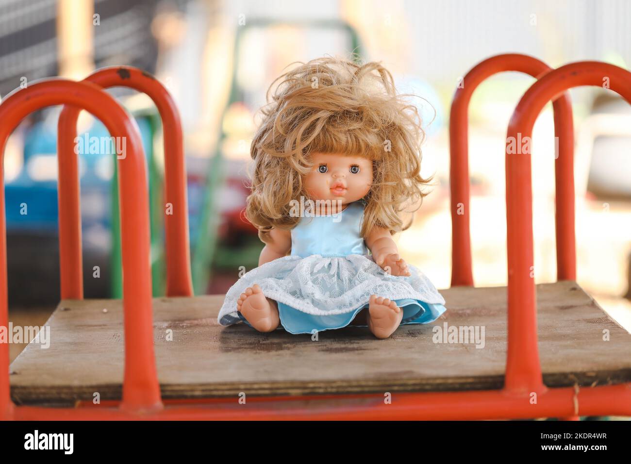 Unruly female doll with messy hair in preschool yard Stock Photo