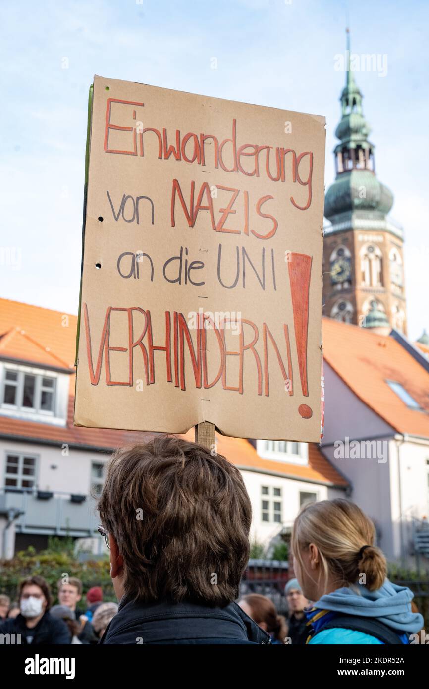 Greifswald, Germany. 08th Nov, 2022. Participants protest with a sign reading 'Prevent Nazi immigration at the university' against a lecture by former AfD member of the state parliament Weber at the University of Greifswald. Weber is chair of civil law, medical law, labor law and legal history at the University of Greifswald. In 2016, he had moved into the state parliament for the AfD. Most recently, he was no longer nominated by the party. Credit: Stefan Sauer/dpa/Alamy Live News Stock Photo