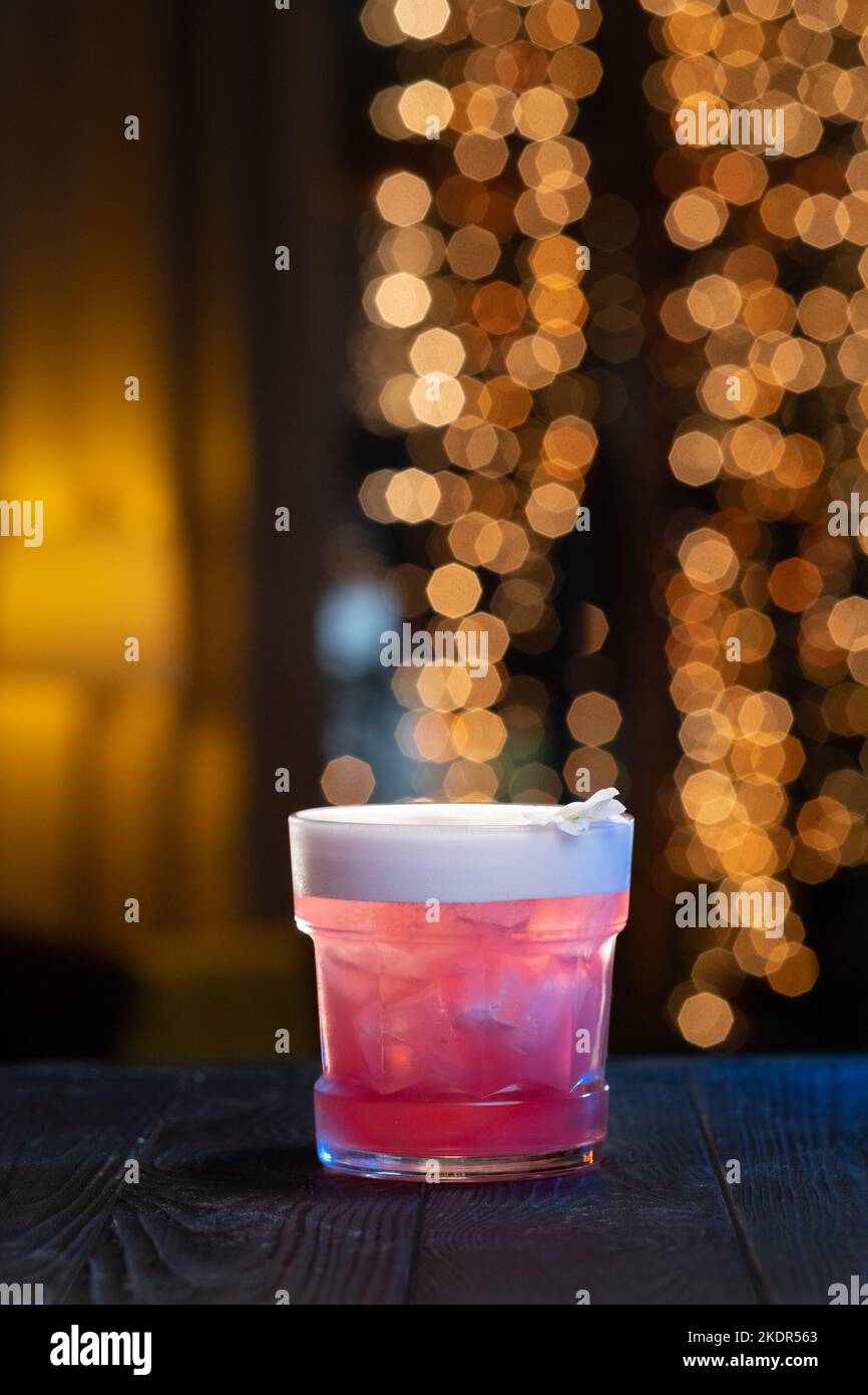 Red cocktail with raspberries in a glass, martini vodka cocktail drink bar ice bartender Stock Photo