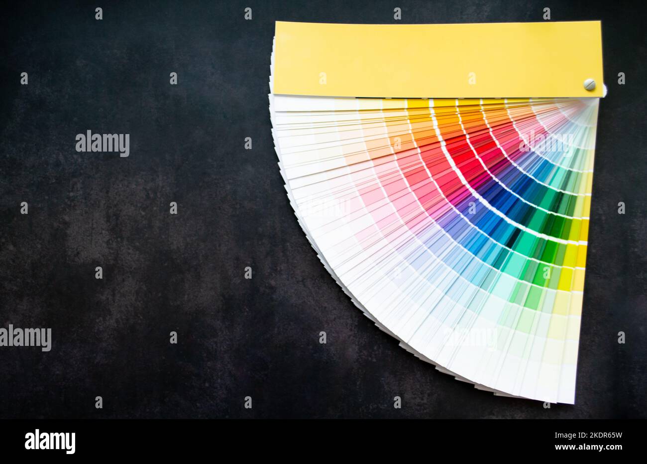 Paper fan paint swatch interior design, wall painting. Black background, copy space. Stock Photo
