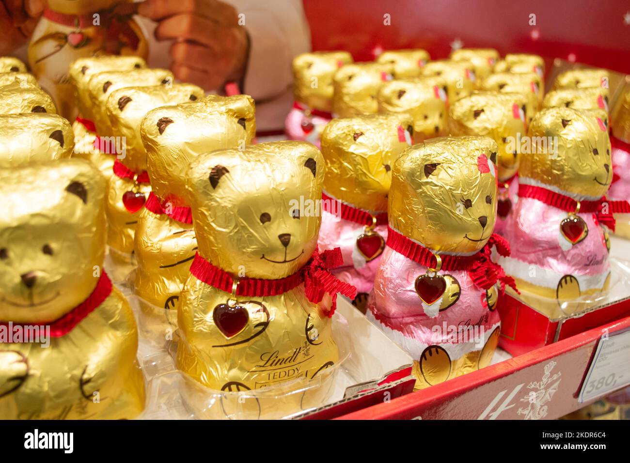 Moscow, Russia, November 2020: Lindt chocolate Teddy bears in gold foil and with a red heart pendant are sold in a supermarket. Stock Photo