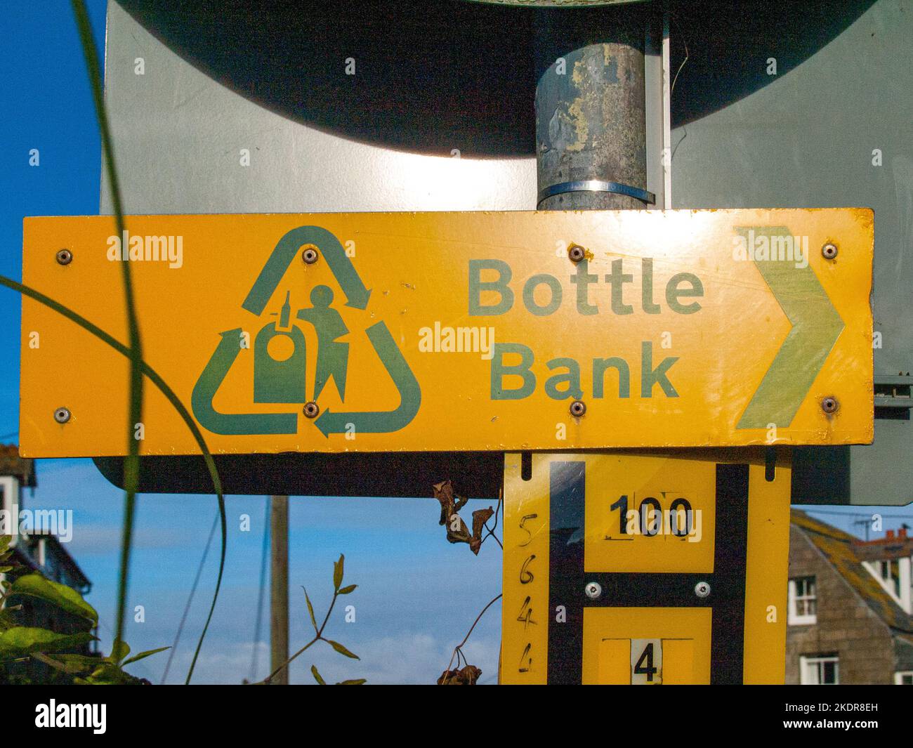 Yellow sign, showing the directon to the next bottle bank in Port Isaac