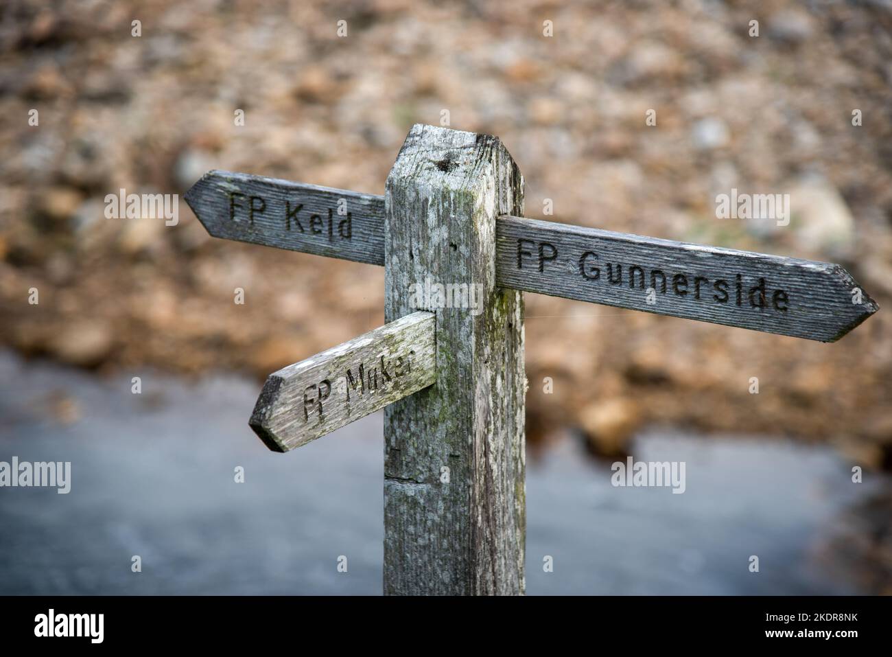 Wooden sign showing the direction to Kled, Muker and Gunnerside at the river swale in the Swaledale in Yorkshire, UK. Stock Photo