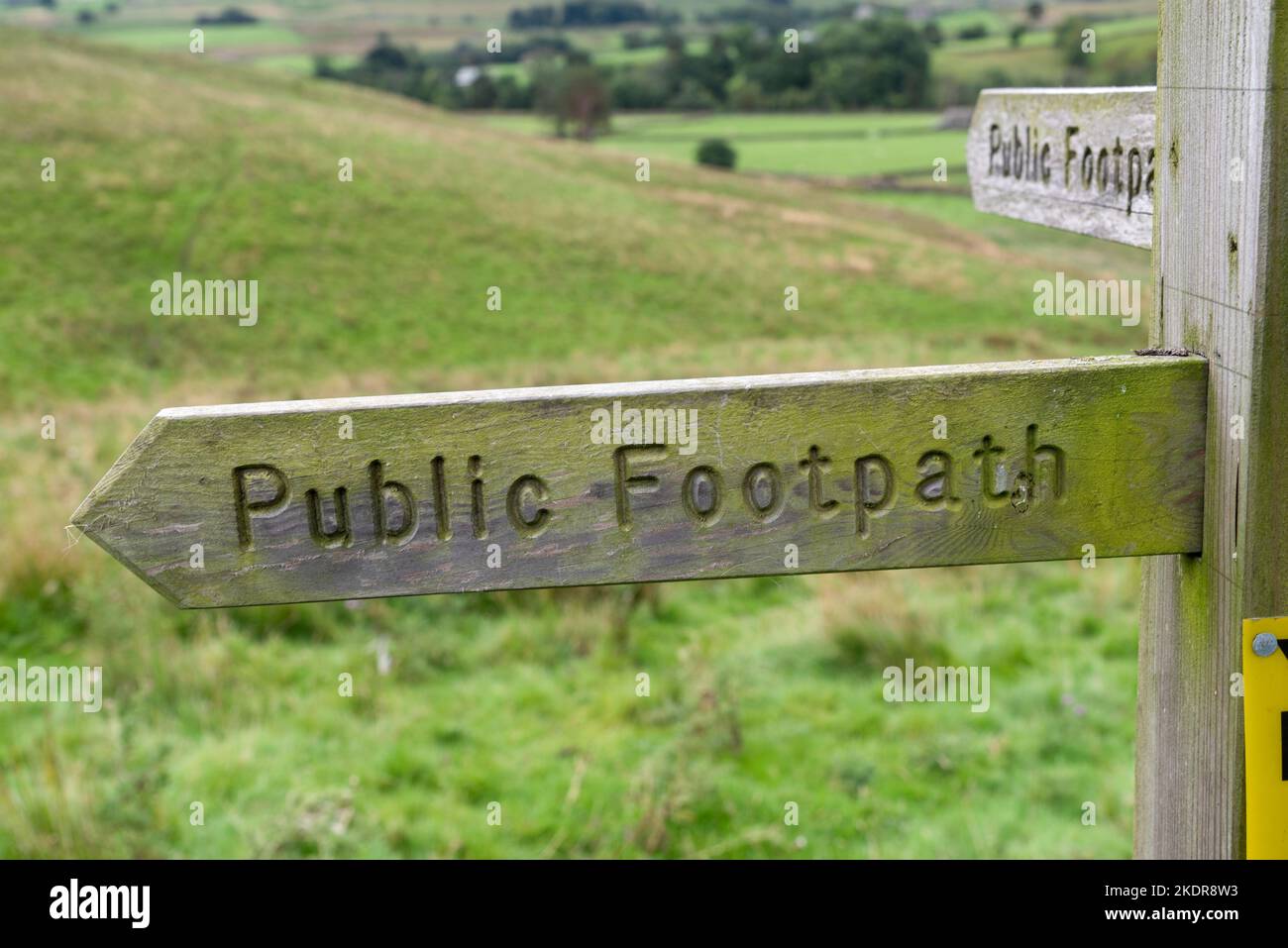 Wooden signpost "Public Footpath" in the Deepdale in the Yorkshire Dales in England, UK. Stock Photo