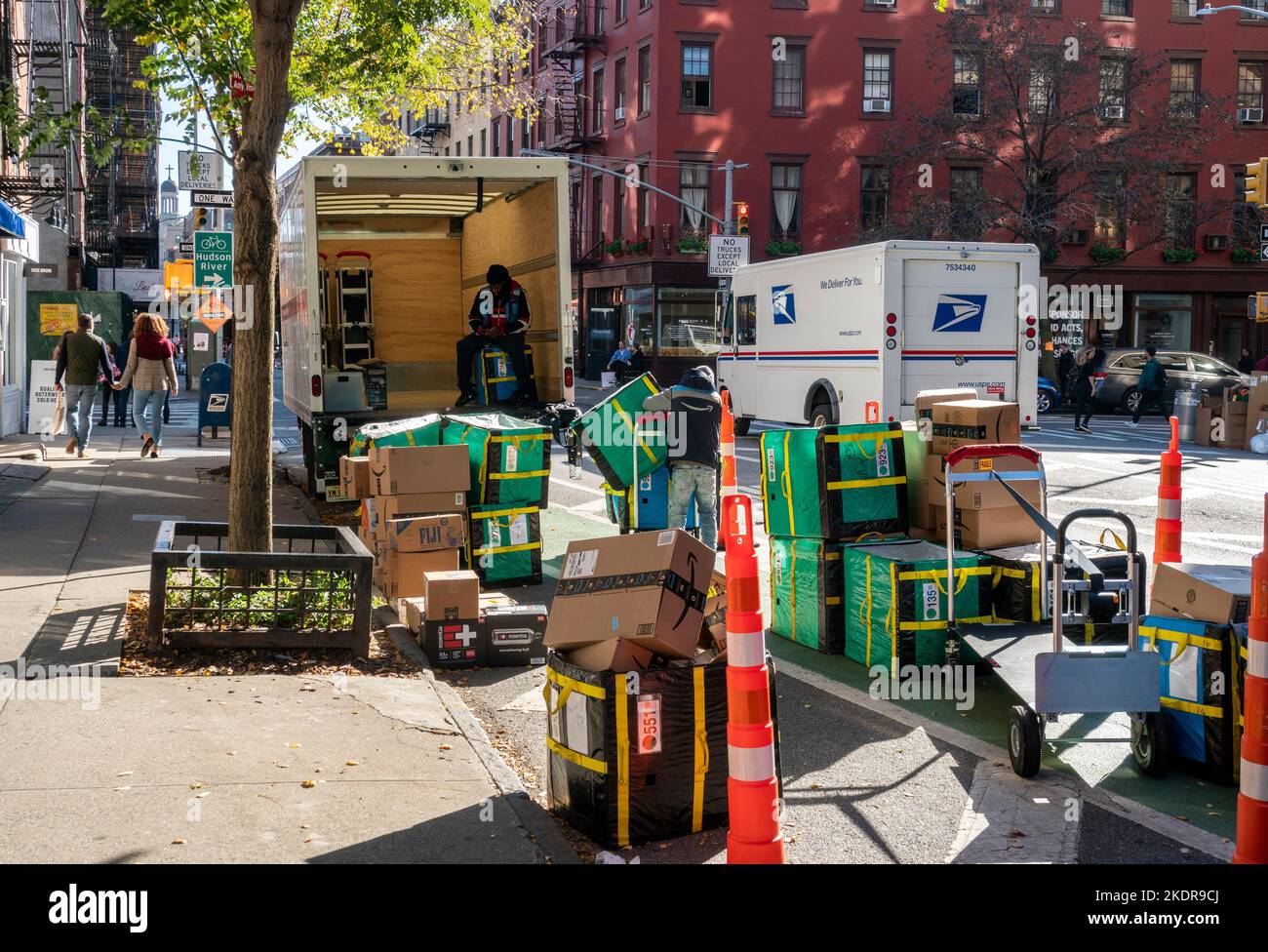 Workers sort Amazon deliveries for distribution in the Greenwich ...