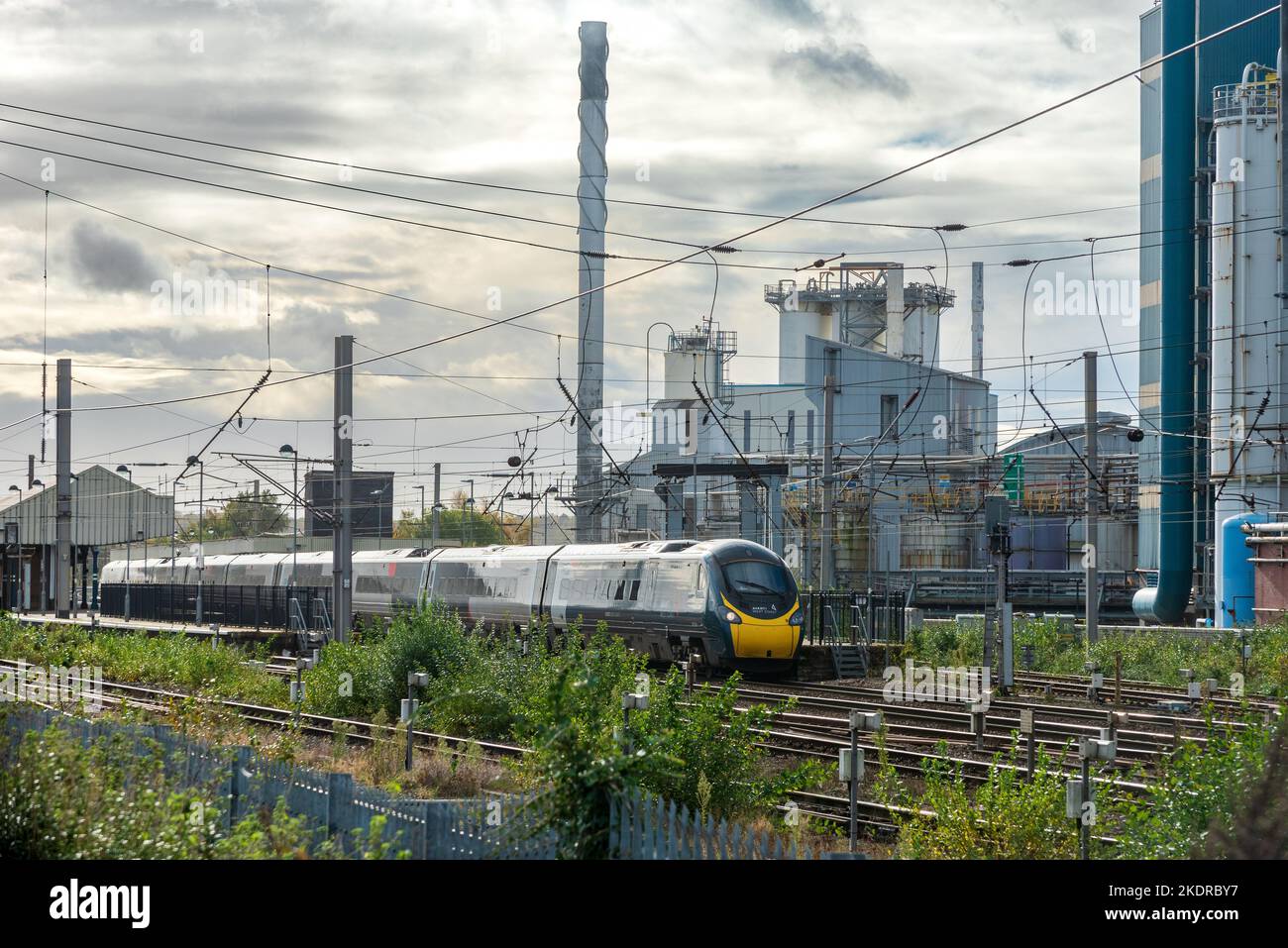 Avanti Pendolino train at Warrington Bank Quay station in front of the closed Lever Faberge factory. Stock Photo