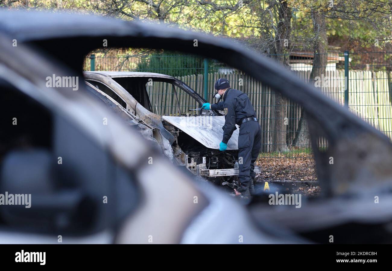 Leipzig, Germany. 08th Nov, 2022. An investigator examines a burned-out vehicle belonging to a real estate company on the company's premises. Unknown persons set fire to the cars, the police do not exclude a political motive. Credit: Sebastian Willnow/dpa/Alamy Live News Stock Photo