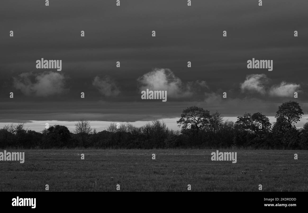 White clouds on dark sky on Middlewick ranges in Colchester, Essex ...