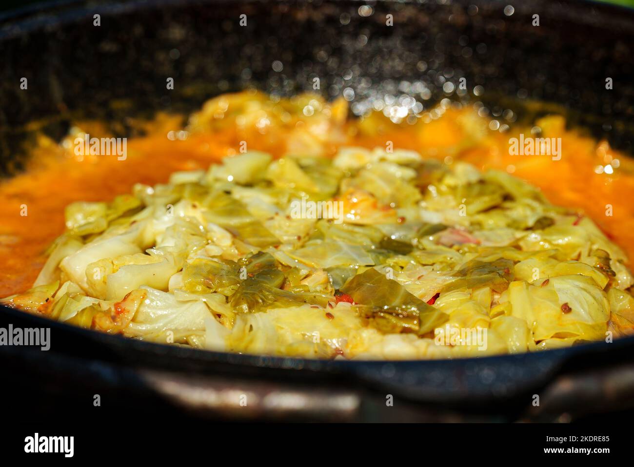 Cabbage is cooked in cauldron on fire. Step by step cooking of Chorba