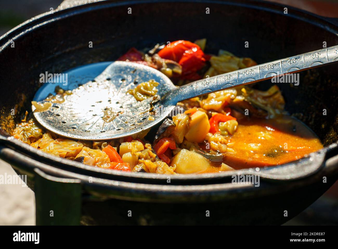 Vegetable Chorba in cauldron on fire. Stock Photo