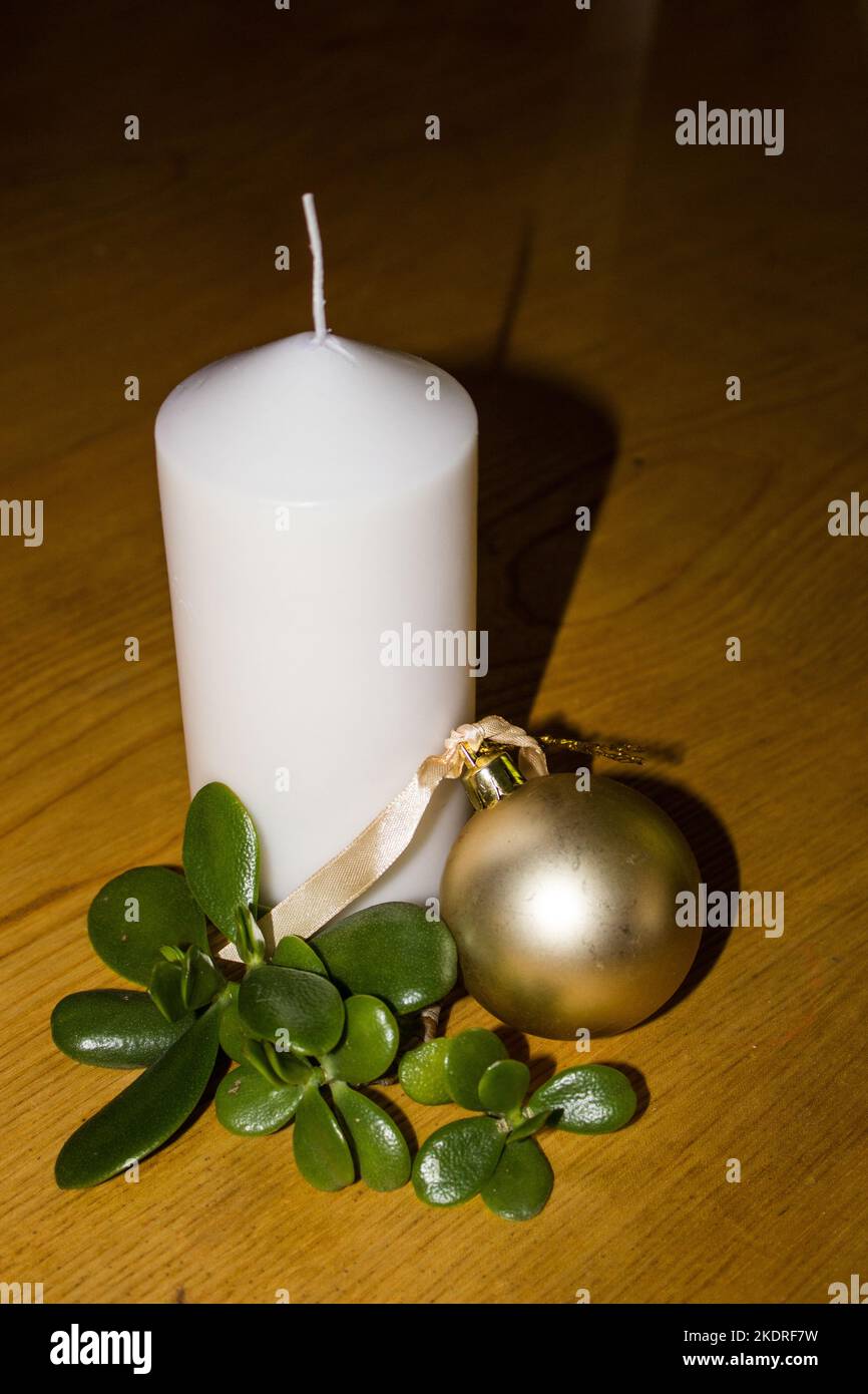 Simplistic Christmas Decoration consisting of a single white unlit Candle Stock Photo