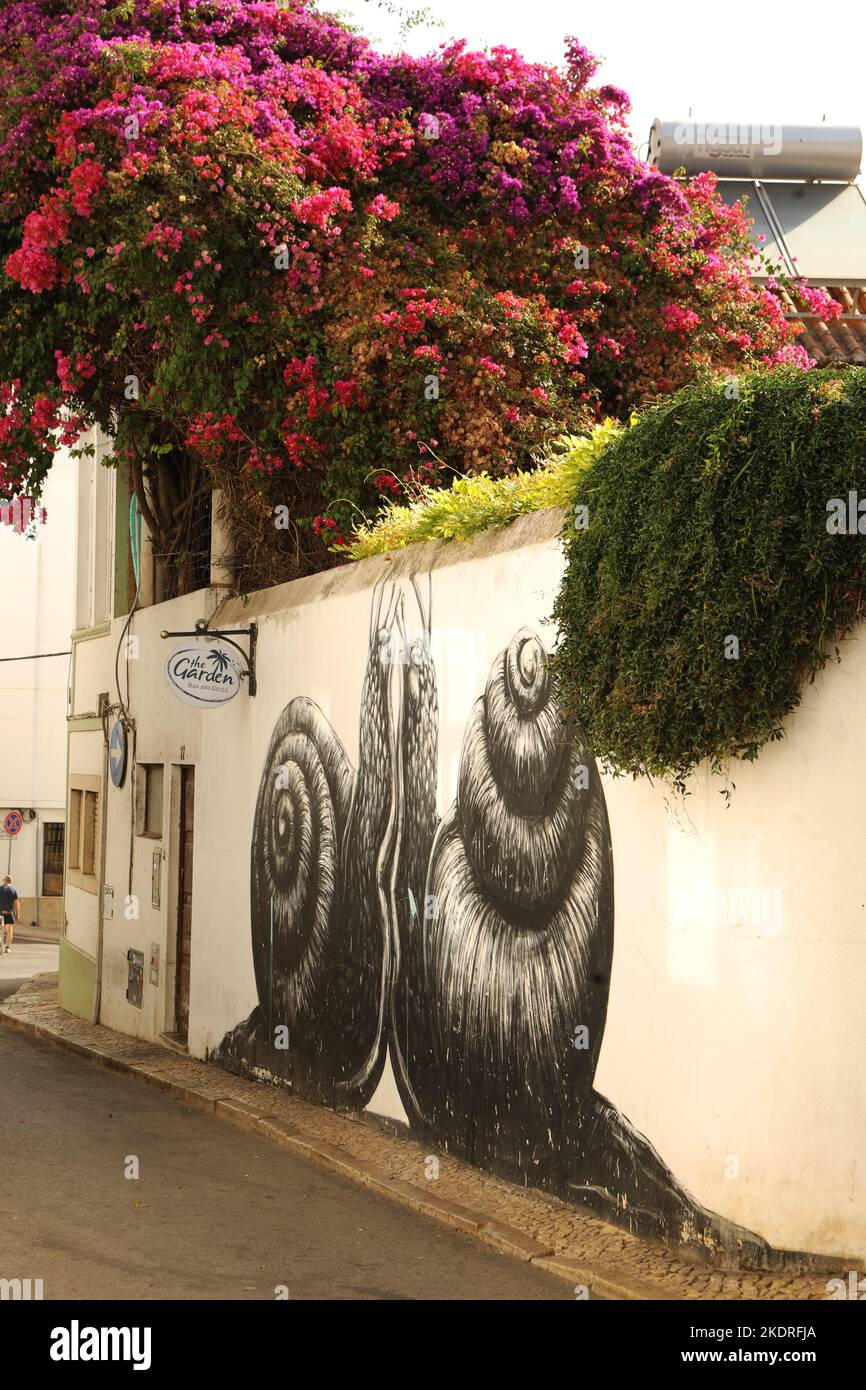 A mural of two snails on a wall in old town, Lagos, Algarve, Portugal Stock Photo