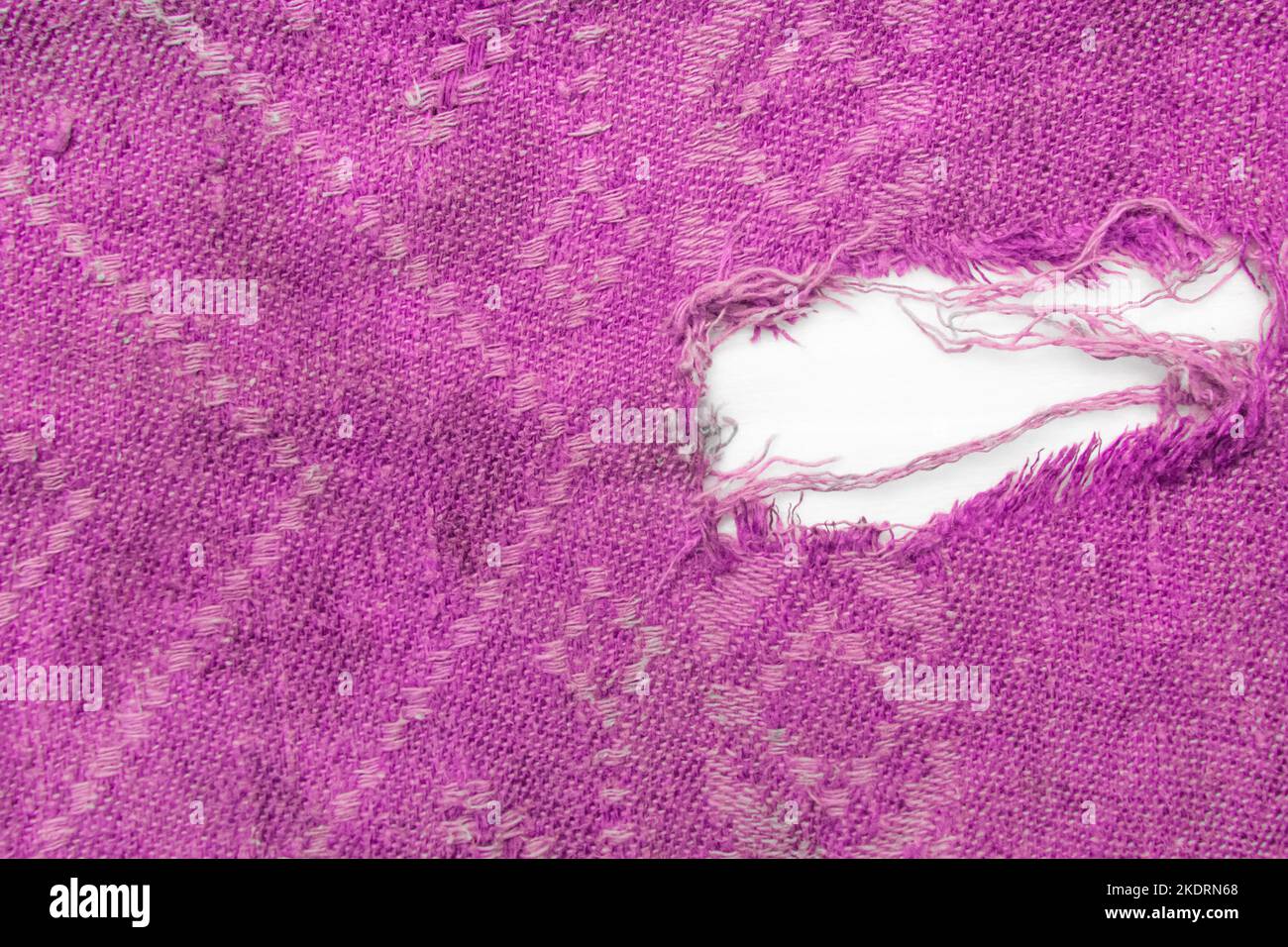Hole torn ripped fabric pink or purple color material old textile