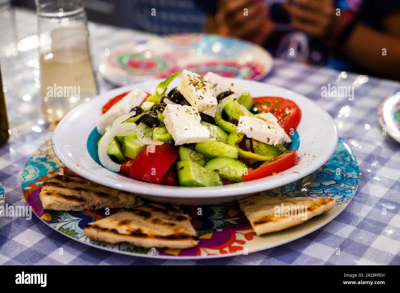 Family eating traditional Greek food in restaurant tavern in Greece