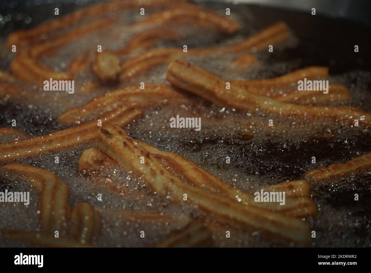 fried churros churro typical mexican sweet while frying cooking detail